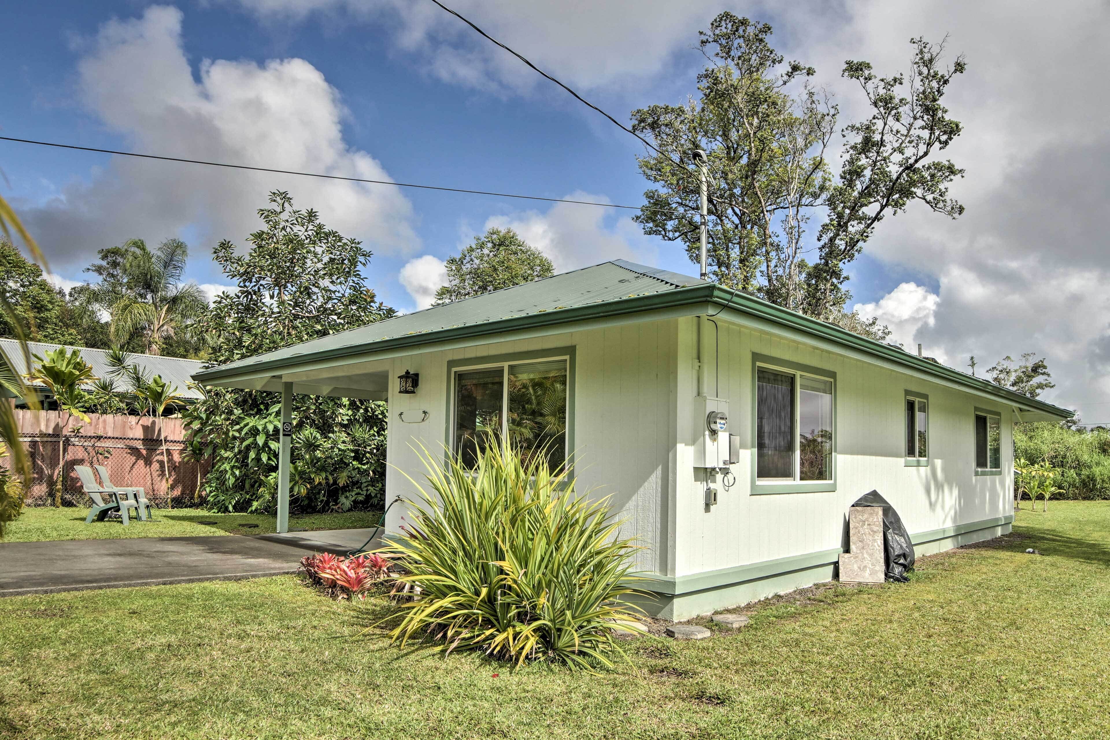 A single-story house with a green roof and a covered porch.