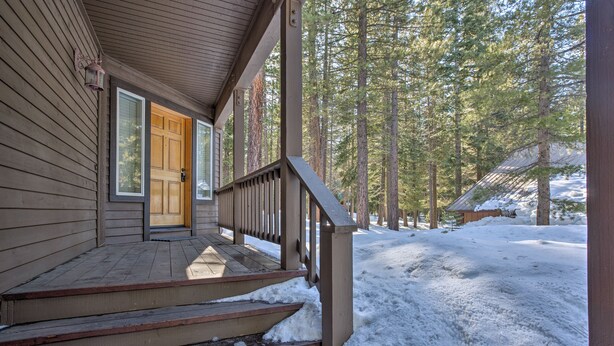 A wooden house with a porch, steps leading to a door, and a snowy yard with trees. - Cabin < 2 Mi to Tahoe Donner Downhill Ski Resort (Truckee)