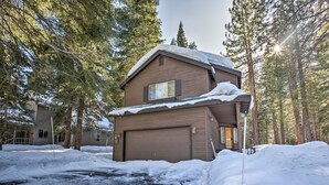 A two-story house with a garage, surrounded by snow and trees. - Cabin < 2 Mi to Tahoe Donner Downhill Ski Resort (Truckee)
