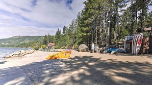 A beach with kayaks and a building with a red roof. - Cabin < 2 Mi to Tahoe Donner Downhill Ski Resort (Truckee)