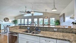 A kitchen with granite countertops, stainless steel appliances, and pendant lighting. - St Augustine Home w/ Swim Spa & Marsh Views! (St. Augustine)