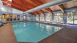 An indoor swimming pool with wooden beams, large windows, and a clear view of the outdoors. - Winter Park Condo w/ Hot Tubs, 4 Mi to Ski Resort! (Winter Park)
