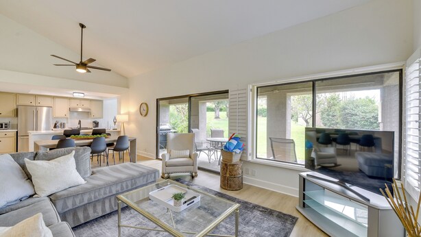 A modern living room with a grey sectional sofa, a glass coffee table, and a flat-screen TV. - Quiet Palm Desert Condo: Workspace & Pool Access! (Palm Desert)