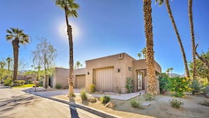 A modern house with a garage, surrounded by palm trees and a well-maintained garden. - Quiet Palm Desert Condo: Workspace & Pool Access! (Palm Desert)