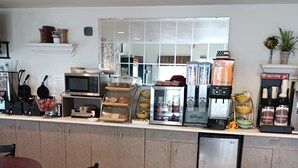 A cafe with a counter, coffee machines, and seating area. - The Westerly Motel (Ocean Shores)
