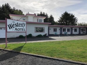 A motel with a sign reading "Westerly Motel" and a parking lot in front. - The Westerly Motel (Ocean Shores)