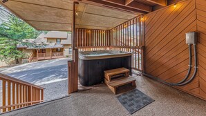 A hot tub with wooden steps, a wooden deck, and a view of the street. - Spacious Ruidoso Retreat w/ Hot Tub & 2 Kitchens! (Ruidoso)