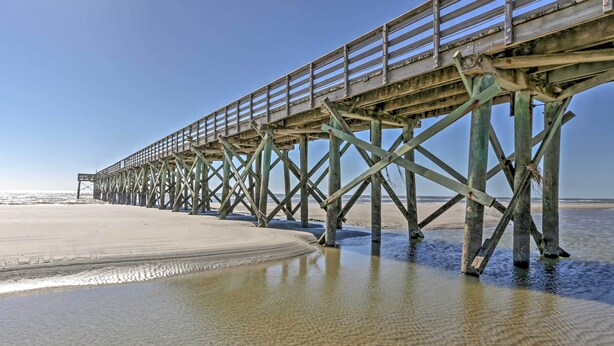 A pier extending into the water with a sandy beach at the end. - Walk to Beach! Isle of Palms Condo w/ Pool Access (Isle of Palms)