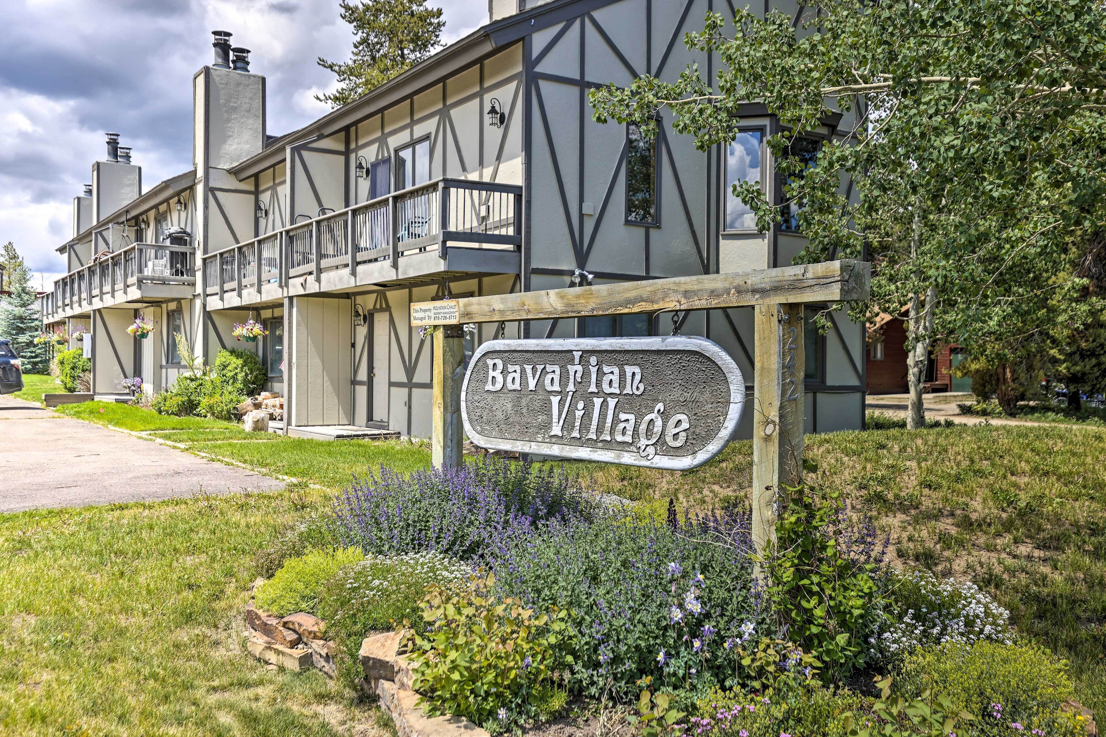A Bavarian Village sign with a traditional half-timbered building in the background.