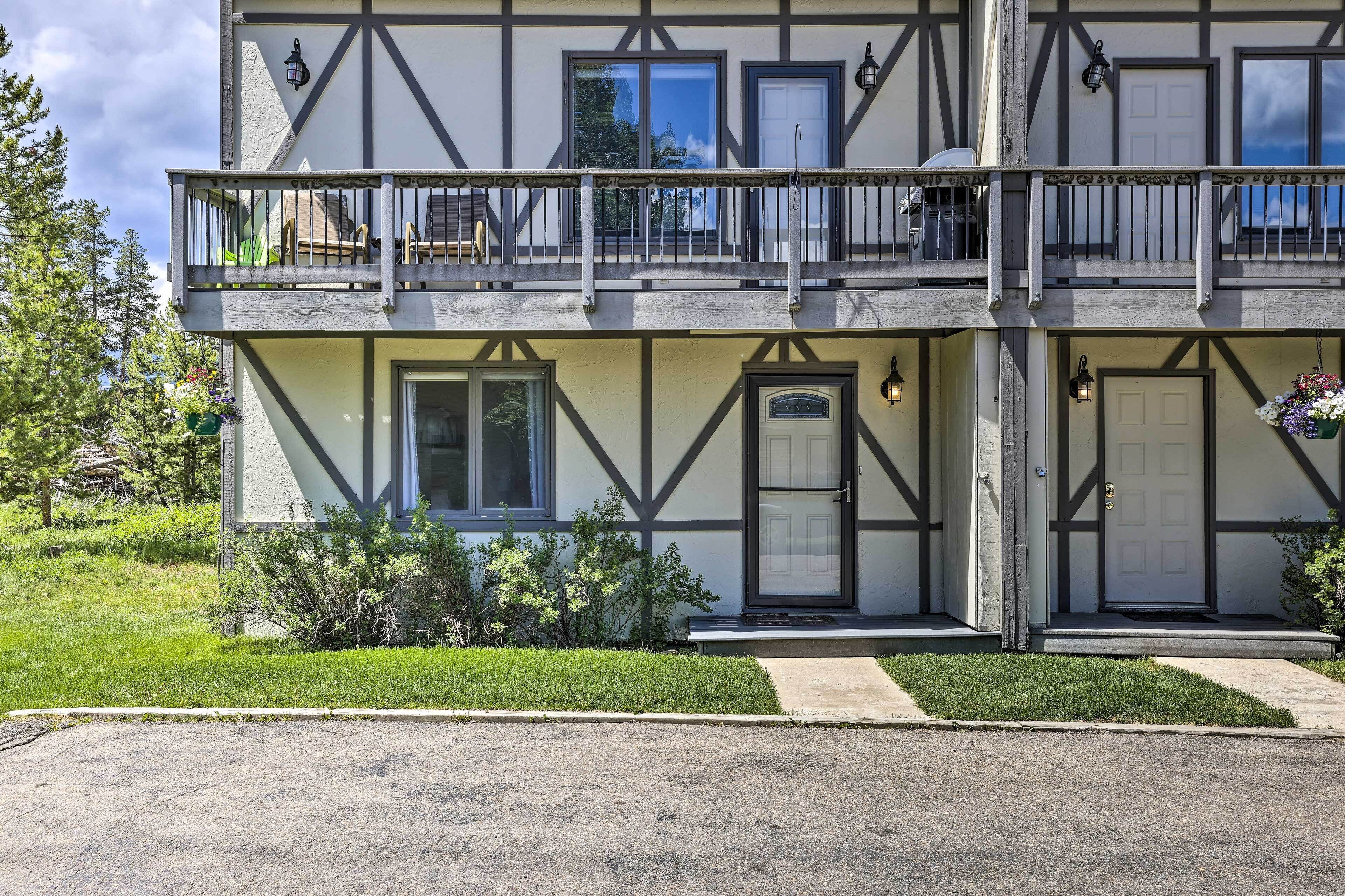 A two-story building with a balcony, a front door, and a small porch area.