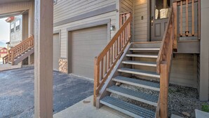A residential building with a front entrance, a garage, and a wooden staircase leading to the entrance. - 8 Mi to Keystone: Mtn-view Ski Retreat! (Silverthorne)