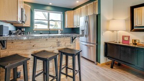 A modern kitchen with wooden cabinets, a stainless steel refrigerator, and a window providing natural light. - 8 Mi to Keystone: Mtn-view Ski Retreat! (Silverthorne)