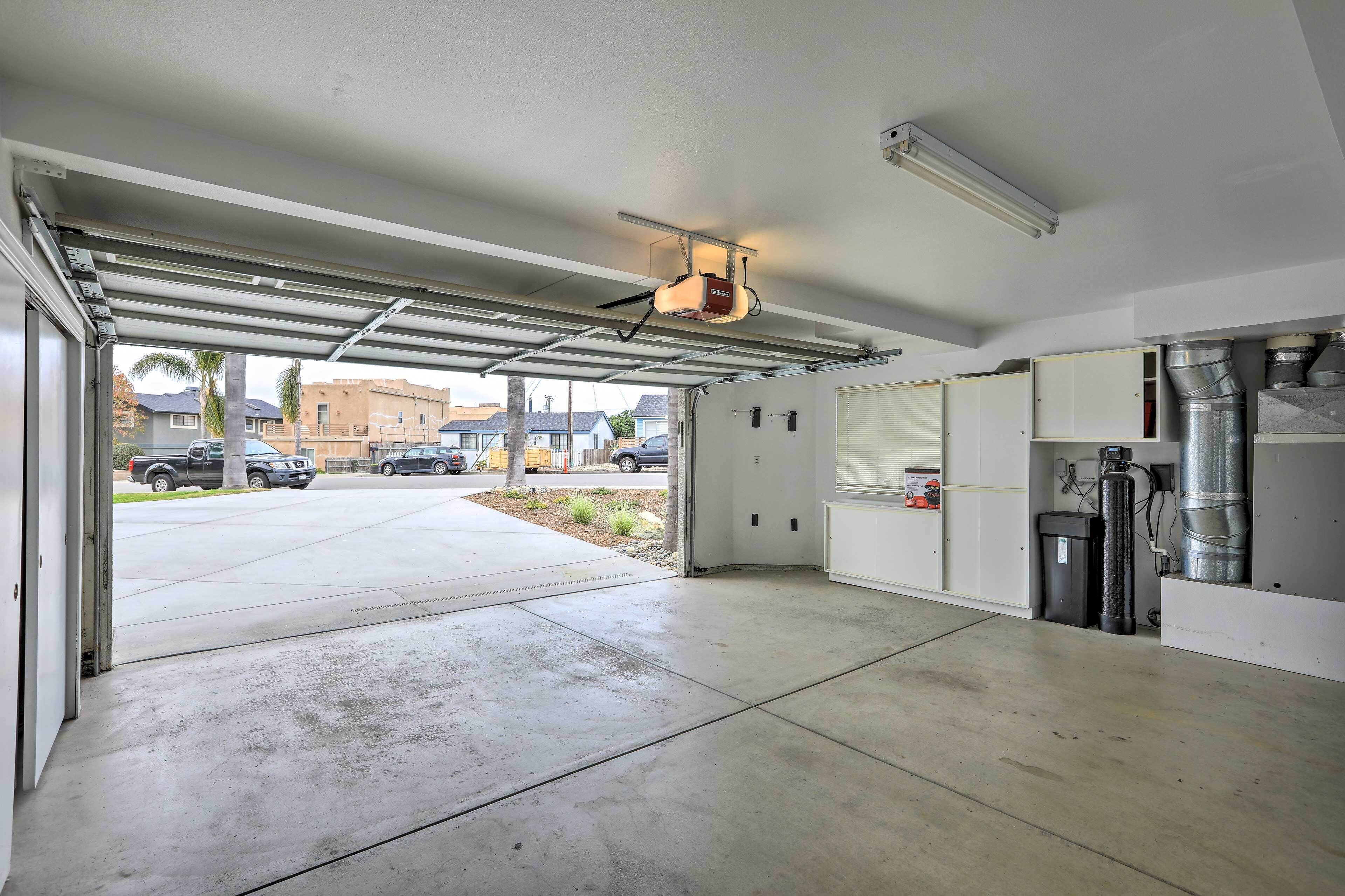 A garage with a concrete floor, a ceiling fan, and a ventilation system.