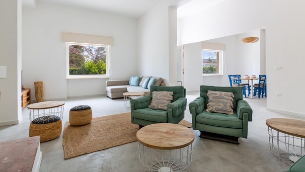 A spacious living room with a green sofa set, round coffee tables, and a large window providing natural light. - 3320 Villa Fiorezza - 3 PT by Barbarhouse (Maruggio)