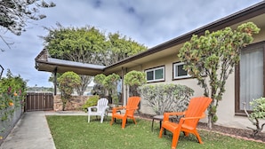 A house with a covered patio, two orange Adirondack chairs, a white chair, and a small lawn. - Cozy San Diego Escape w/ Yard, Near Beaches! (San Diego)