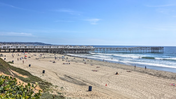 A beach with a pier extending into the ocean, sandy beach, and a clear sky. - Cozy San Diego Escape w/ Yard, Near Beaches! (San Diego)
