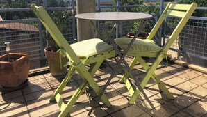 A balcony with a table and two chairs, potted plants, and a view of the landscape. - A bright and sunny one-bedroom apartment with a private terrace and a beautiful, unobstructed view. (Aix-en-Provence)