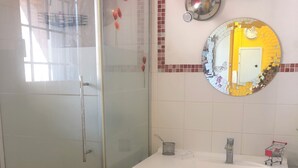 A bathroom with a glass shower enclosure, a sink with a mirror, and red cabinets. - A bright and sunny one-bedroom apartment with a private terrace and a beautiful, unobstructed view. (Aix-en-Provence)
