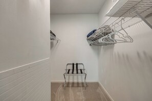 A narrow hallway with a metal drying rack on the right and a chair in the center. - < Half-mi to Fort Clinch Beach! Condo w/ Balcony (Fernandina Beach)
