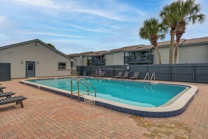 A rectangular swimming pool with a blue border, surrounded by a brick patio. - < Half-mi to Fort Clinch Beach! Condo w/ Balcony (Fernandina Beach)