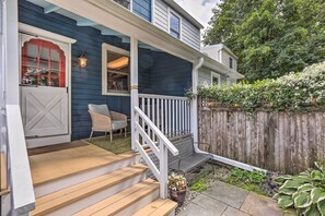 A house with a porch, wooden steps, a white railing, and a wooden fence. - Charming Lambertville Retreat - 1 Mi to River! (Lambertville)