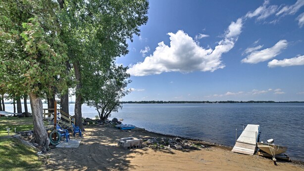 A lakeside campsite with a dock, a covered seating area, and a sandy beach. - 'willow Point' ~ Lake Champlain House w/ 2 Kayaks! (Isle La Motte)