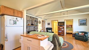 A compact living space with a kitchenette, a bed, a sofa, and a reading area. - 'willow Point' ~ Lake Champlain House w/ 2 Kayaks! (Isle La Motte)