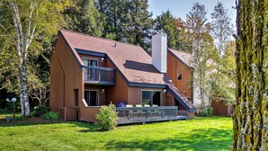 A modern two-story house with a sloped roof, a balcony, and a chimney. - Stowe Vacation Rental w/ Deck & Mountain Views! (Stowe)