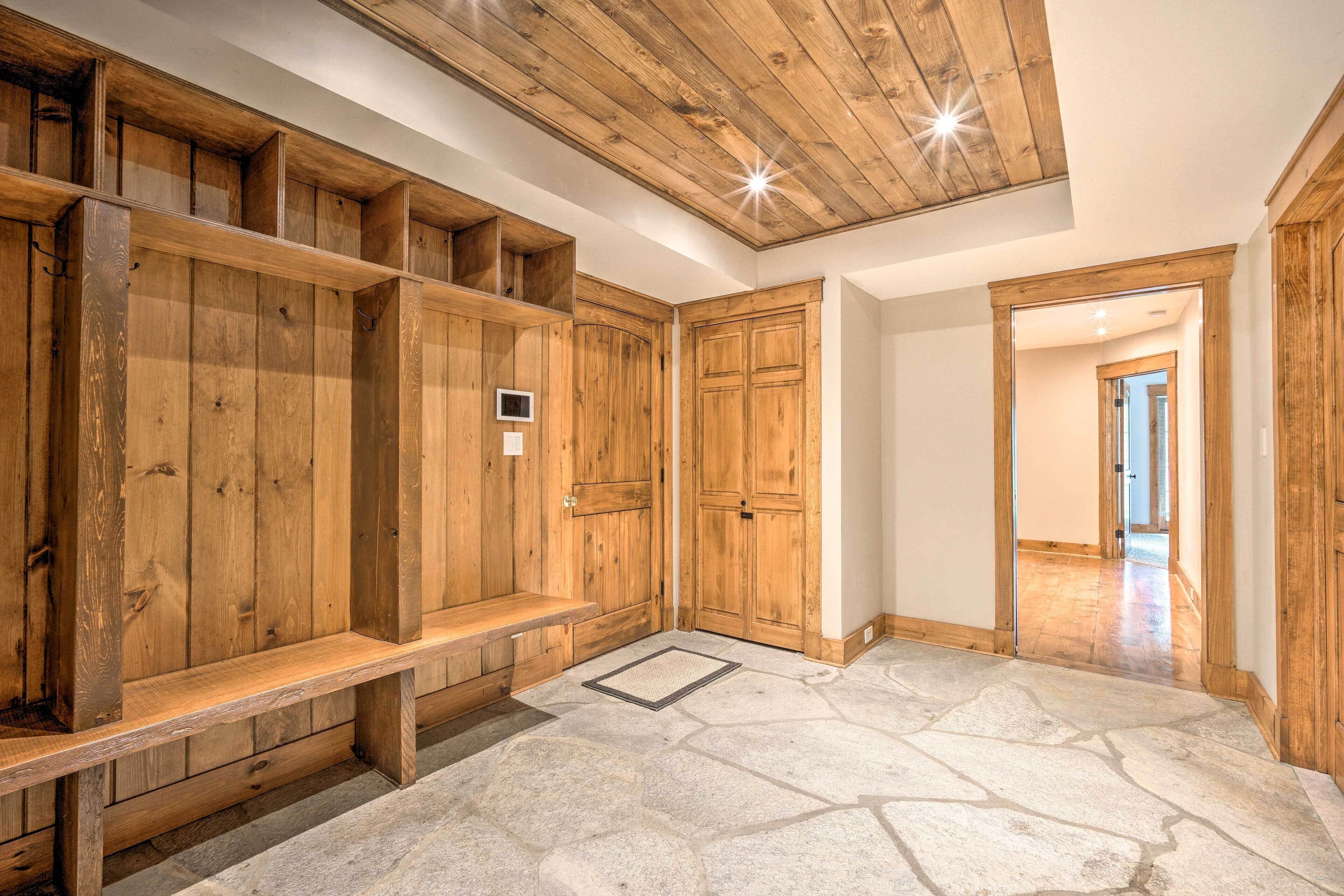 A wooden interior with a stone floor, wooden benches, and a ceiling with exposed beams.