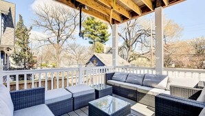 An outdoor deck with wicker furniture and a wooden ceiling. - Updated Baltimore Home 8 Mi to Downtown! (Baltimore)