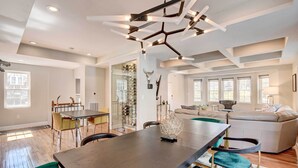 A spacious living area with a dining table, chairs, and a sofa. - Updated Baltimore Home 8 Mi to Downtown! (Baltimore)