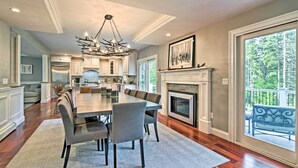 A spacious dining area with a large table and chairs, a fireplace, and a view of the outdoors. - West Dover Home - 3 Miles to Mount Snow Resort! (West Dover)