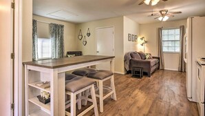 A compact living space with a kitchenette, a dining area with bar stools, a sofa, and a ceiling fan. - Cozy Canyon Lake Cottage: 1 Mi to Guadalupe River! (Canyon Lake)