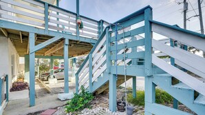 A blue wooden staircase leading to a covered outdoor area with a concrete floor and a small garden. - PCB Apt w/ Balcony & Gulf Views: Walk to Beach (Panama City Beach)