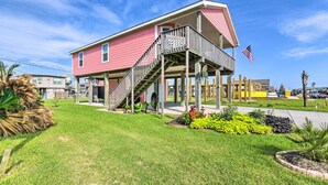 A two-story house with a balcony and a flag. - Walk to Sea Isle Beach: Bright Galveston Home! (Galveston)