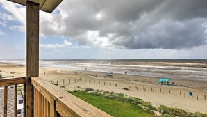 A beach view from a wooden deck with a view of the ocean and a cloudy sky. - Villa Azul Galveston Home: Modern & Beachfront! (Galveston)