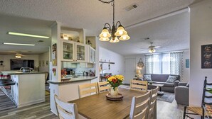 A spacious living area with a wooden dining table, chairs, and a kitchen in the background. - 2 Living Rooms: Crescent City Home (Crescent City)