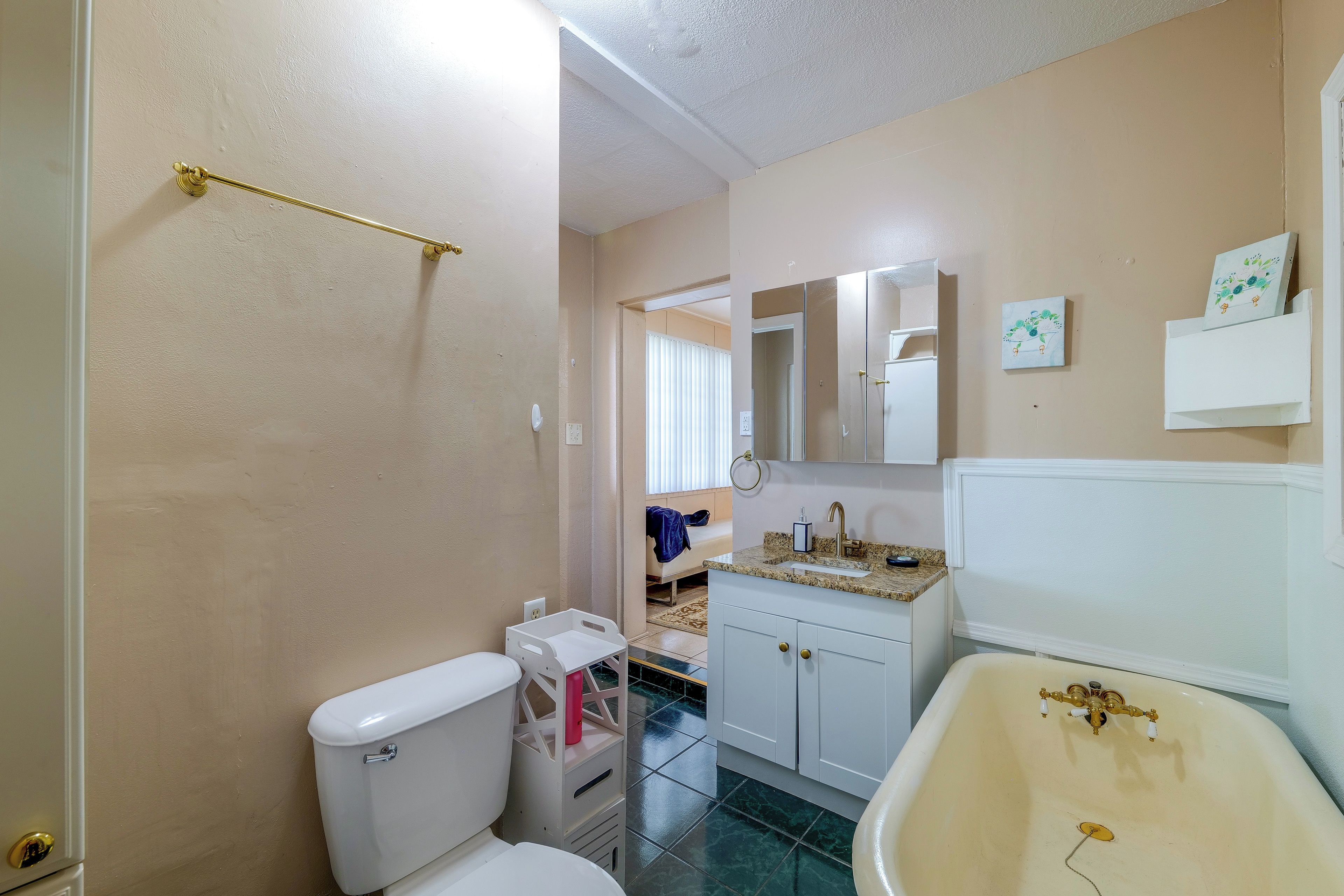 A bathroom with a toilet, a sink, and a bathtub.