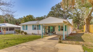 A single-story house with a covered porch, a front yard, and a large tree to the right. - Walk to Beach: Fort Walton Coastal Retreat (Fort Walton Beach)