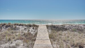 A wooden boardwalk leading to a beach with clear turquoise water. - Breezy PCB Retreat w/ Direct Beach Access! (Panama City Beach)