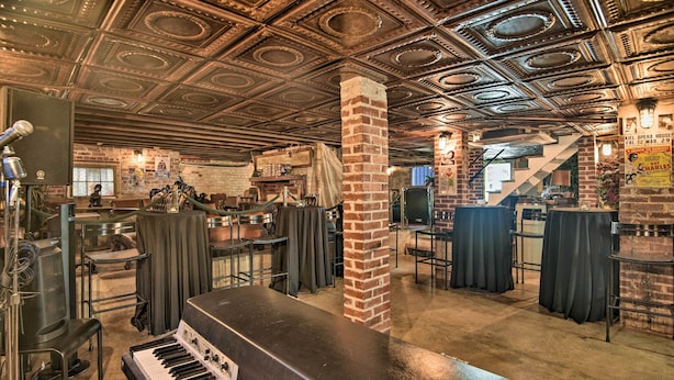 A spacious venue with a grand piano, brick columns, and a high, ornate ceiling. - Historic Home < 2 Mi to Daytona Beach & Pier! (Daytona Beach)