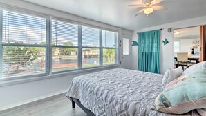 A bedroom with a large window, a ceiling fan, and a view of the outside. - Canalfront Hudson Home W/private Dock & Yard! (Hudson)