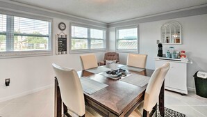 A dining area with a wooden table, four chairs, a kitchen area with a coffee maker, and a chalkboard menu on the wall. - Canalfront Hudson Home W/private Dock & Yard! (Hudson)
