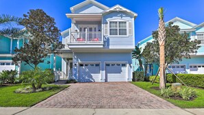 A two-story house with a front porch, a garage, and a well-maintained lawn.