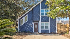 A two-story house with a dark blue siding exterior, a brown front door, and a small porch area. - A-frame Retreat in Pensacola, 10 Mi to Dtwn (Pensacola)