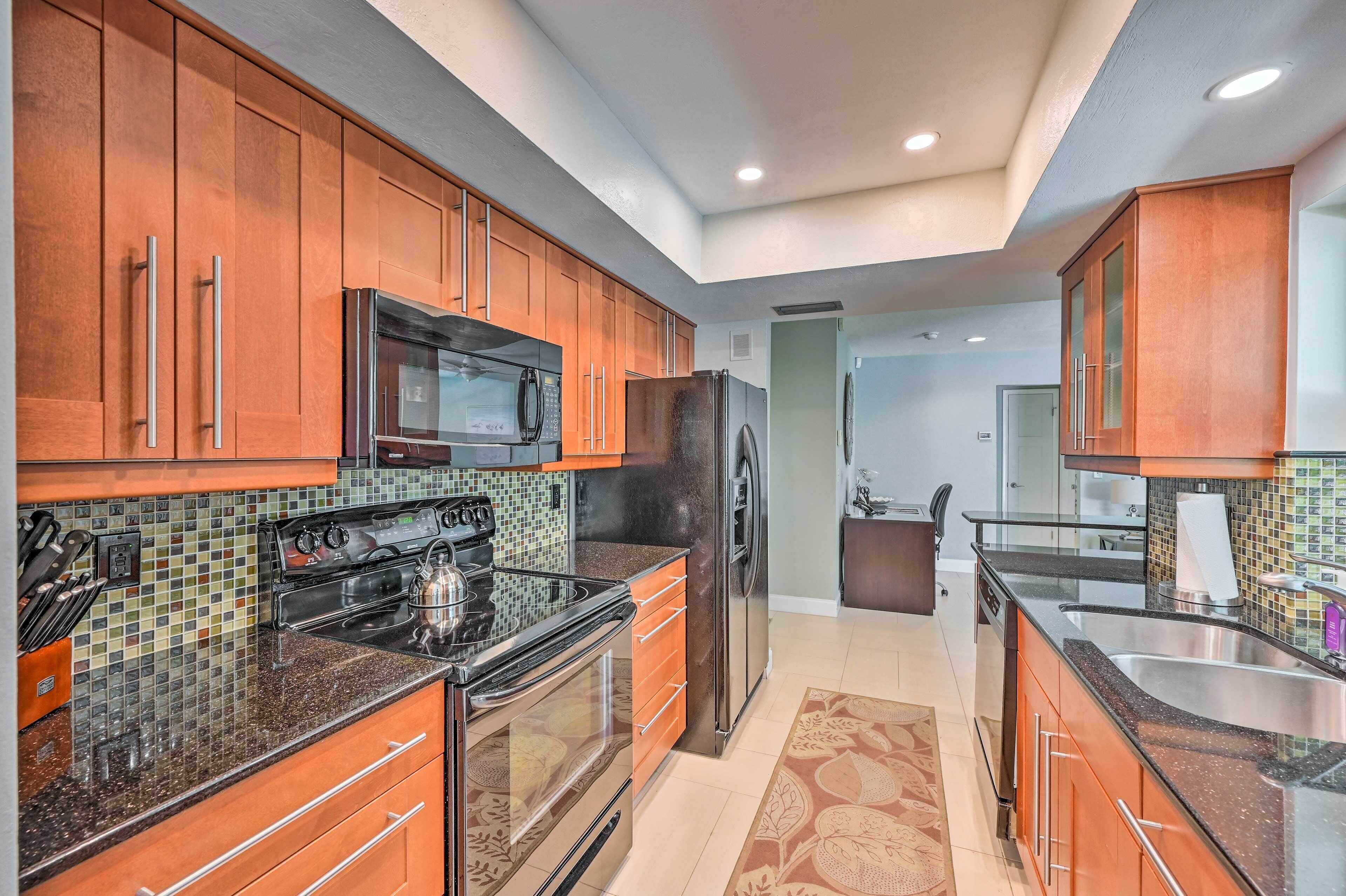 A modern kitchen with wooden cabinets, stainless steel appliances, and a tiled backsplash.