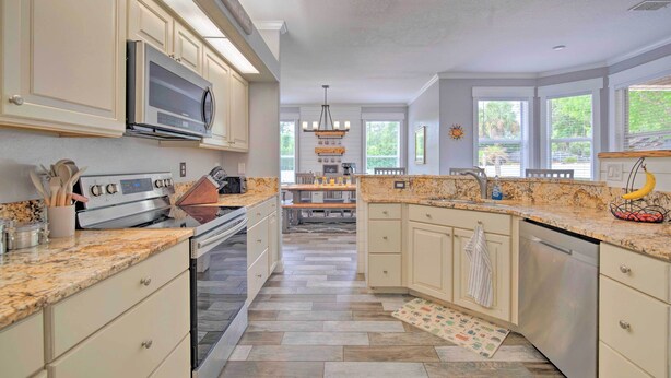 A spacious kitchen with granite countertops, stainless steel appliances, and a central island.