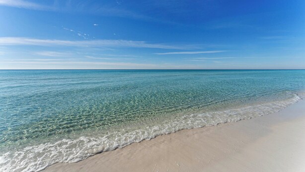 A beach with clear water, a sandy shore, and a clear sky. - Miramar Beach Retreat - Beachfront & Poolside (Miramar Beach)