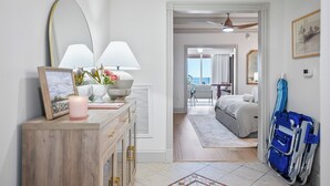 A hotel room with a bed, bedside table, lamp, and a wheelchair. - Sunny Hammock Beach Condo: Balcony w/ Ocean Views! (Palm Coast)