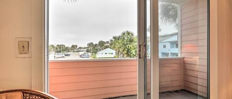 A room with a sliding glass door leading to a balcony.